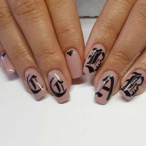 Premium AI Image | a nail art design with flowers and letters on it.